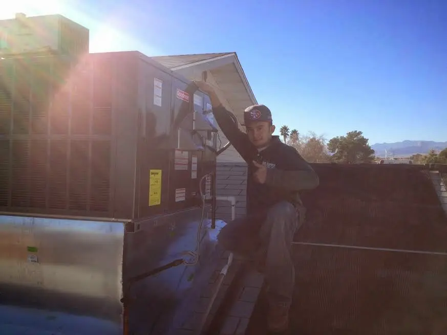 HVAC technician performing HVAC Inspection on a rooftop unit in Truth or Consequences